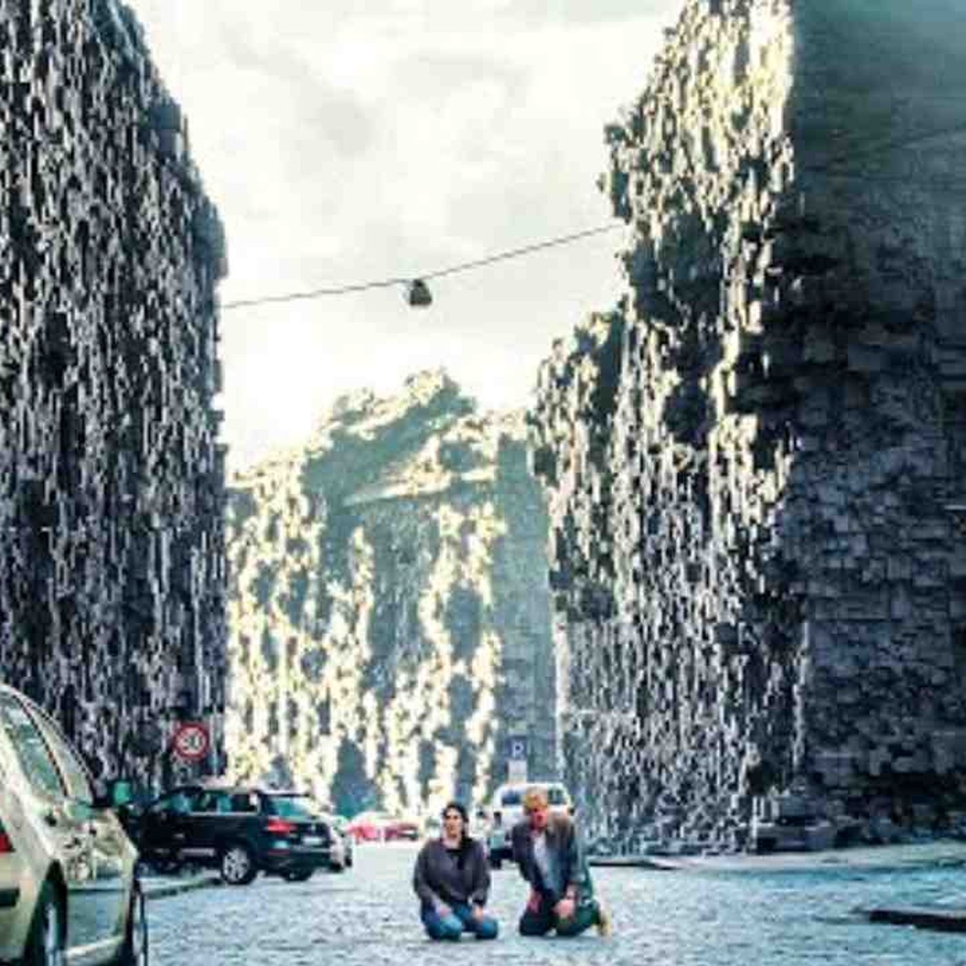 A couple wakes up and discovers all the buildings surrounded by strange black bricks episode artwork
