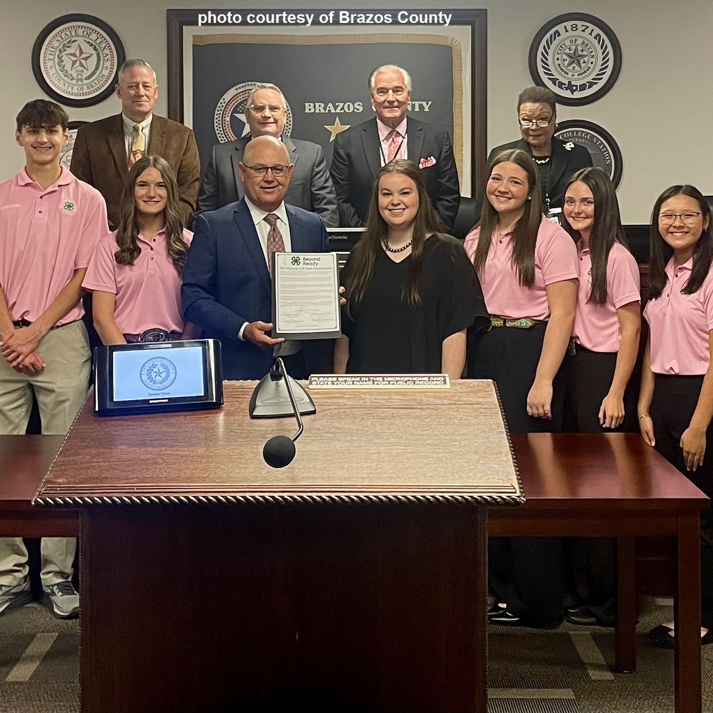 Brazos County 4-H Council and 4-H Agents receive a county commission proclamation for National 4-H Week