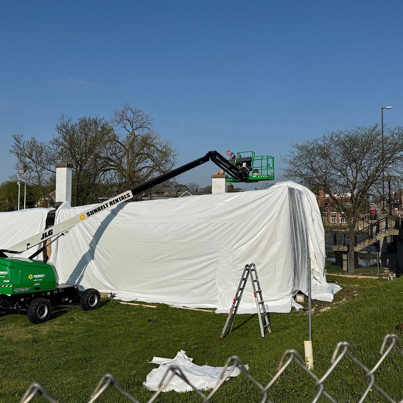 Geneva blacksmith shop shrink-wrap flap persists; city cites developer over plastic cover episode artwork