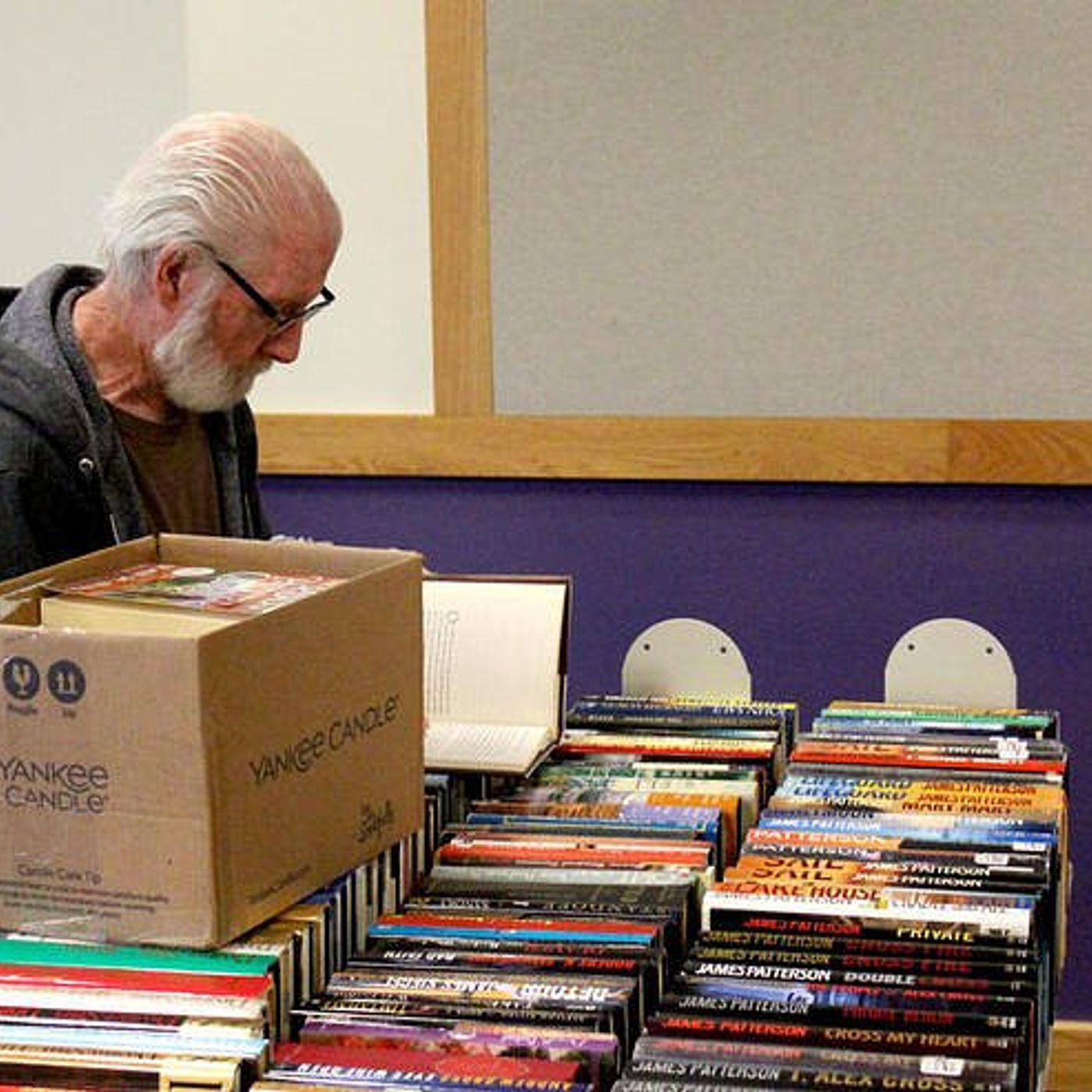 Plano Library holding Friends of the Library book sale episode artwork