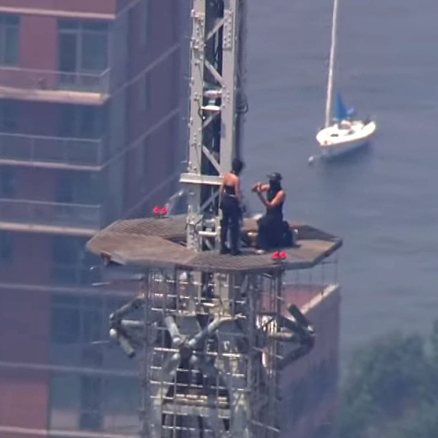 2 people climb to top of Empire State Building and fly banner episode artwork