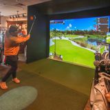 Gonzo and Amy take on a golf simulator at Crystal Mountain