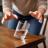 Hands shaking over glass