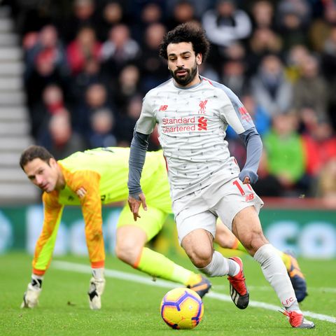 Salah treble fires Liverpool top of the table
